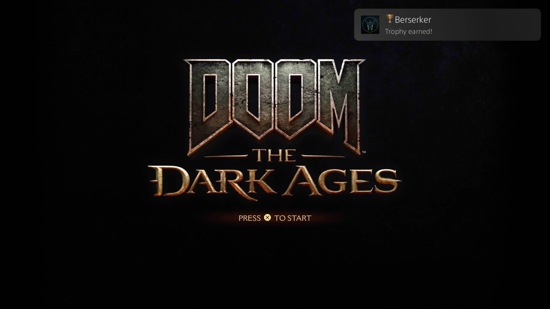 Image of DOOM: The Dark Ages title screen with the PlayStation 5 'Berserker Trophy Earned' popup in the top right hand of the screen.