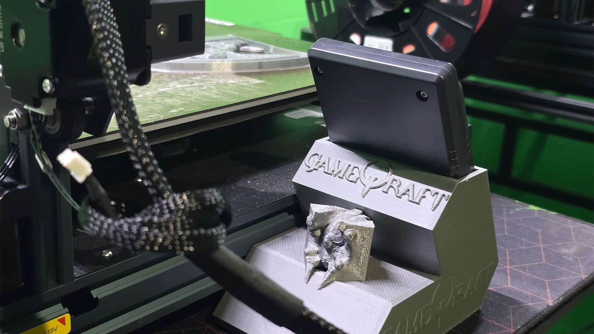 The GameQraft logo, printed onto a tablet stand.